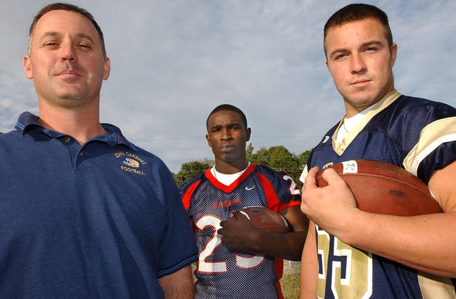 All area football coach Lenny Jankowski, of John Carroll, left, along with Jarvis Drayton, running back for Centennial and Stephen Purkey, defensive end for John Carroll. 2003