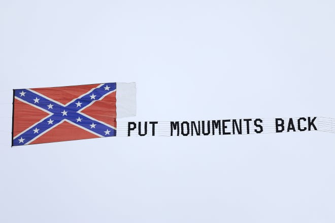 An airplane flies overhead with a banner and a Confederate message before a regular season NFL football matchup between the Jacksonville Jaguars and the Baltimore Ravens Sunday, Nov. 27, 2022 at TIAA Bank Field in Jacksonville. [Corey Perrine/Florida Times-Union]