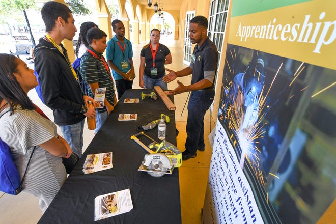 Waine Weeks (right), of Florida Training Services Inc., explains carpentry, career opportunities and and apprenticeship programs to students interested in skilled trades from Sebastian River and Jensen Beach high schools during the State of Jobs Conference on Thursday, Oct. 3, 2019, at the Port St. Lucie Civic Center.