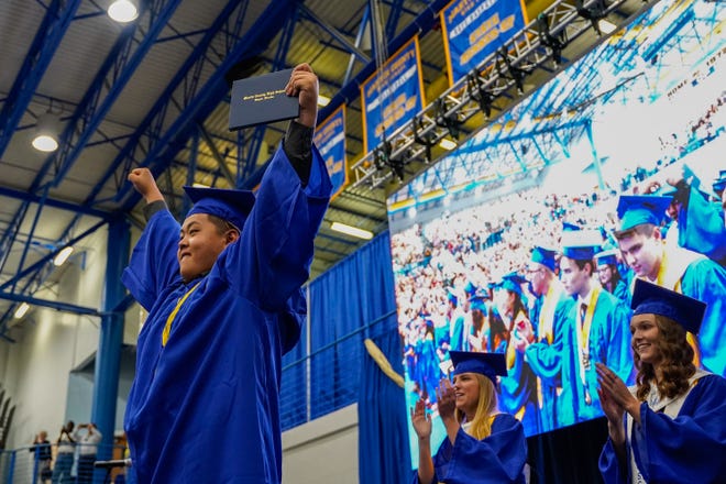 Graduating senior Yang Zihao accepts his diploma during Martin County High School's class of 2022 commencement ceremony Tuesday, May 24, 2022, at Martin County High School in Stuart.