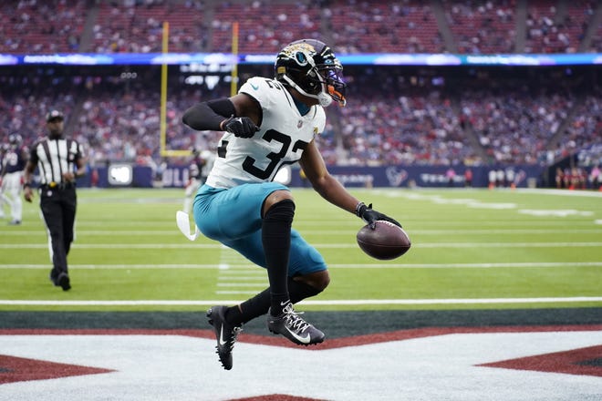 Jacksonville Jaguars cornerback Tyson Campbell (32) celebrates after scoring a touchdown on a fumble recover during the first half of an NFL football game against the Houston Texans in Houston, Sunday, Jan. 1, 2023. (AP Photo/Eric Christian Smith)