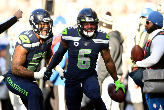 Seattle Seahawks safety Quandre Diggs (6) celebrates after intercepting a pass during the first half of an NFL football game against the Las Vegas Raiders Sunday, Nov. 27, 2022, in Seattle. (AP Photo/Caean Couto)