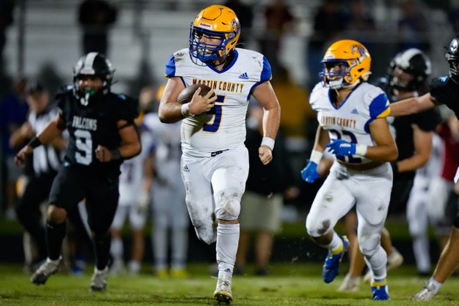 Martin County’s quarterback Pauly Boisvert (5) runs the ball to score a touchdown against Jensen Beach in a high school football game on Thursday, Nov. 3, 2022, at Jensen Beach High School.