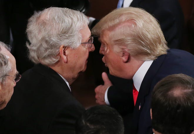 Senate Minority Leader Mitch McConnell, left, seemingly taunted former President Donald Trump on Jan. 4 by joining President Joe Biden on an infrastructure victory lap that was punctuated with a handshake.