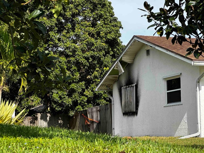 Burn marks surround one of the the windows on the 495 Southwest Harbor Street home where sheriff's detectives say Reginald Chapman Jr. attacked his father and started a fire.