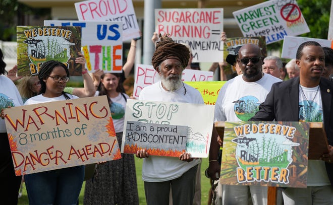 People participate in a protest in downtown West Palm Beach, across from Florida Crystals' corporate headquarters, to protest the start of another sugarcane burn season. The purpose of the protest was to draw attention to life-threatening harms caused by pre-harvest sugar field burning in Florida. Saturday, Oct. 1, 2022 in West Palm Beach.
