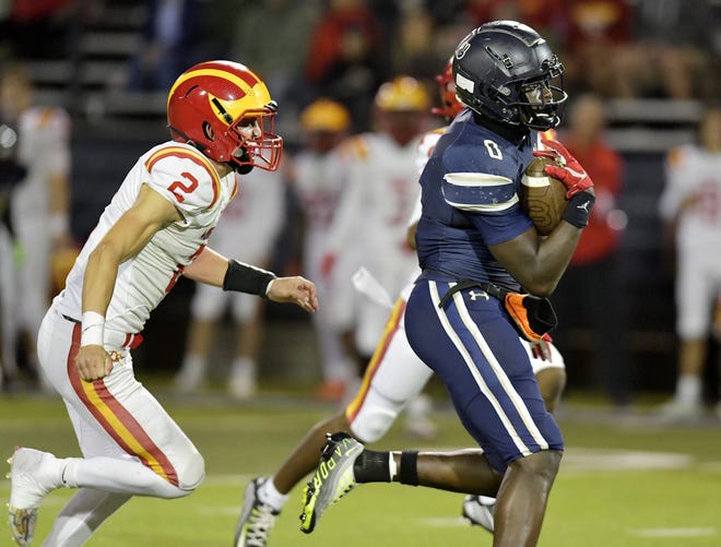 University Christian's Desirrio Riles (0) pulls in a pass from University Christian's Dwayne Stucky (14) while being defended by Clearwater Central Catholic's Andy Jaffe (2) during first quarter action. The Clearwater Central Catholic Marauders traveled to Jacksonville, FL to take on the University Christian Christians in the Florida High School Athletic Association Class 1M starts football semifinal match Friday, December 2, 2022. The Marauders came away with a 29 to 34 win over the Christians. [Bob Self/Florida Times-Union]