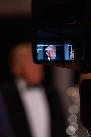Former President Donald Trump is seen through a TV camera viewfinder while speaking to media at Mar-A-Lago on New Years Eve on Saturday, December 31, 2022, in Palm Beach, FL.