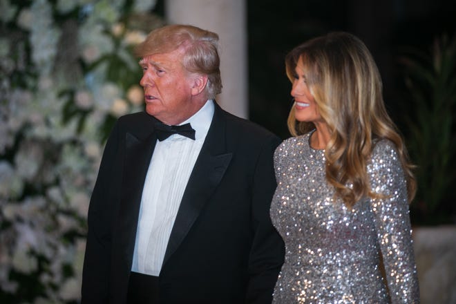 Former President Donald Trump and his wife, Melania Trump, approach the Mar-A-Lago ballroom on the red carpet on New Years Eve on Saturday, December 31, 2022, in Palm Beach, FL.