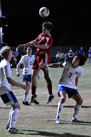 Seminole Ridge's Marcello Serpenti rises highest for possession of the ball during the Hawks' district quarterfinals victory against Martin County on Jan. 25, 2023.