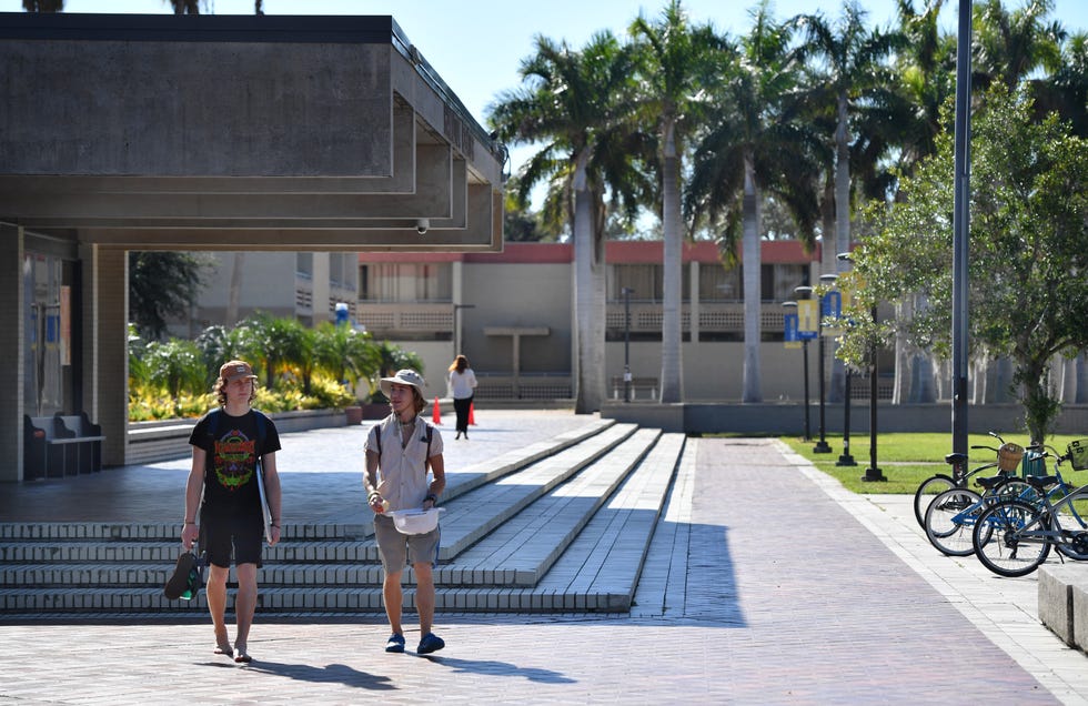 Students walk on the New College of Florida campus on Monday, Jan. 9, 2023 in Sarasota. Florida Gov. Ron DeSantis overhauled the board of Sarasota's New College on Friday, bringing in six new members in a move his administration described as an effort to shift the school in a conservative direction.