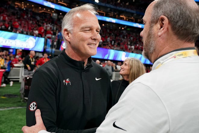 ATLANTA, GEORGIA - DECEMBER 31: Former Georgia Bulldogs head coach Mark Richt greets Chick-fil-A Peach Bowl CEO Gary Stokan during the 2022 College Football Playoff Semifinal at the Chick-fil-A Peach Bowl on December 31, 2022 in Atlanta, Georgia. (Photo by Paul Abell/Chick-fil-A Peach Bowl)