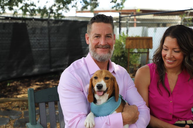 U.S. Rep. Greg Steube holds Huckleberry Finn, a 10-month-old beagle puppy rescued from Envigo, a controversial  government breeding facility. Pictured with Steube is his wife, Jennifer Steube, who is the board president of the Humane Society of Sarasota County.