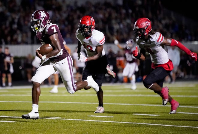 First Baptist Academy Lions quarterback Rich Mellien (7) runs past Munroe Bobcats defenders and scores during the third quarter of the Class 1S state semifinal at First Baptist Academy in Naples on Friday, Dec. 2, 2022.