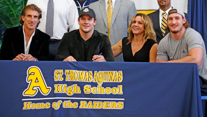 Ohio State freshman Nick Bosa is shown here at St. Thomas Aquinas High School on national signing day with his family; father John Bosa, Nick, mother Cherly and brother Joey who played for Ohio State.