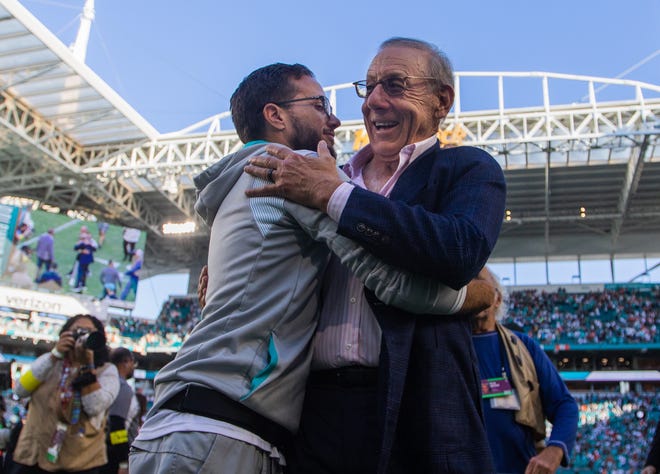Coach Mike McDaniel and owner Stephen Ross celebrate the Dolphins heading back to the playoffs.