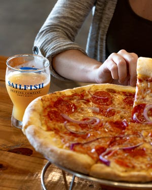 The pizza kitchen at Sailfish Brewing Company in Fort Pierce tosses its own fresh dough daily.