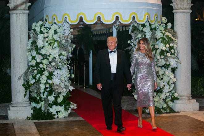 Former President Donald Trump and his wife, Melania Trump, approach the Mar-A-Lago ballroom on the red carpet on New Years Eve on Saturday, December 31, 2022, in Palm Beach, FL.
