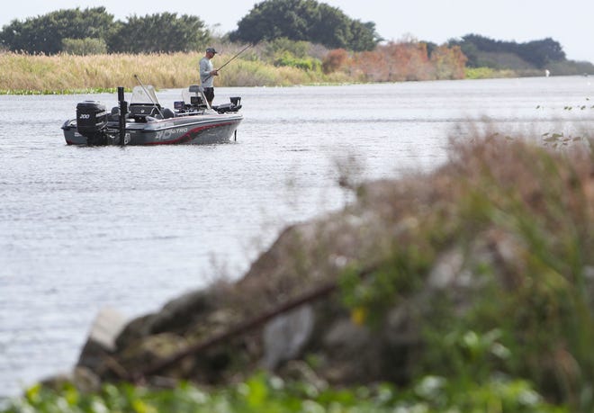 A fisherman searches for a bite along the Herbert Hoover Dike after a ribbon cutting ceremony for the Herbert Hoover Dike rehabilitation project in Clewiston on Wednesday, Jan. 25, 2023.