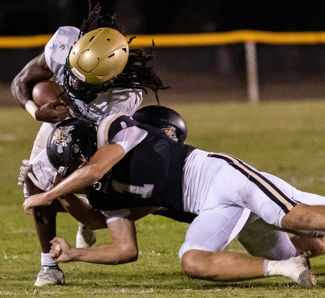 Donny Hiebert (1) tackles Sam Singleton (2) during the first half of the game at Citizens Field in Gainesville, FL on Thursday, October 27, 2022. [Jesse Gann/Gainesville Sun]