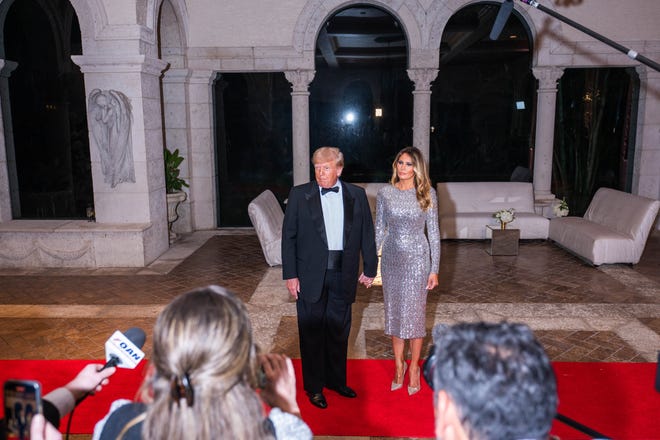 Former President Donald Trump and his wife, Melania Trump, stop to speak to media at Mar-A-Lago on New Years Eve on Saturday, December 31, 2022, in Palm Beach, FL.