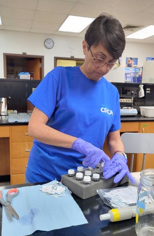 An ORCA scientist works with water samples collected from the Indian River Lagoon.