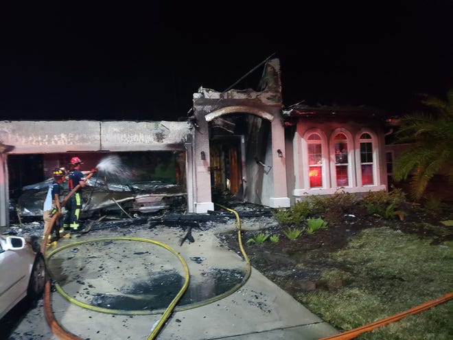 Clay County firefighters hose down a home that was destroyed following a blaze that was started by discarded New Year's Eve fireworks. (Clay County Fire Rescue)