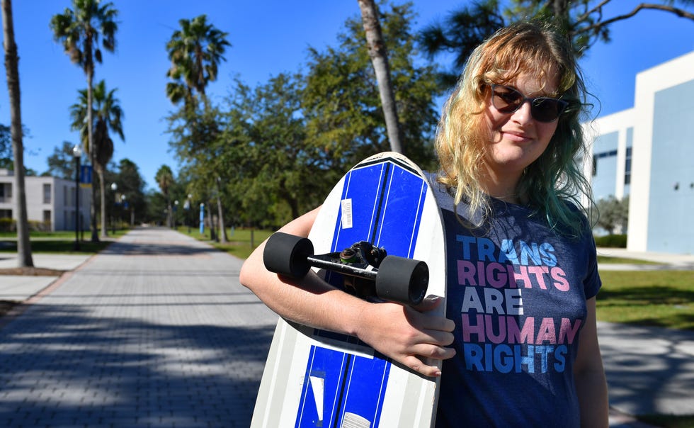 Sam Sharf, 22, poses for a photo with her longboard on the Bayfront Campus at New College of Florida on Monday, Jan. 9, 2023. Sharf is studying international relations.  Florida Gov. Ron DeSantis overhauled the board of Sarasota's New College on Friday, bringing in six new members in a move his administration described as an effort to shift the school in a conservative direction.