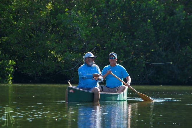 CCA president Andy Steinbergs, foreground, and Frank Gidus, CCA habitat & conservation director, background, fish the Indian River Lagoon from a canoe.