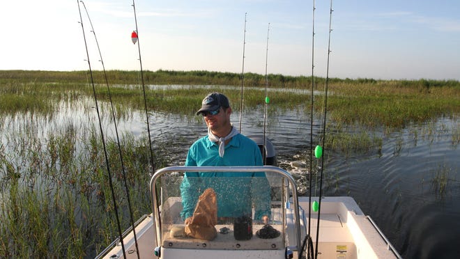 Hendry County Commissioner Karson Turner navigates Lake Okeechobee while looking for some good fishing spots.