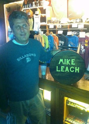 Mike Leach poses with the bar stool with his name that has a permanent spot at Capt. Tony's Saloon in Key West.