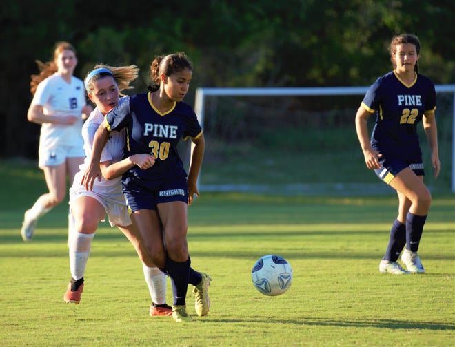 Pine School's Giovanna Waksman is defended by Alma Czajkowski of St. Edward's during a high school soccer match on Friday, Dec. 9, 2022 in Hobe Sound. Waksman scored twice in the second half to earn a hat trick and added an assist in a 6-0 Knight win.