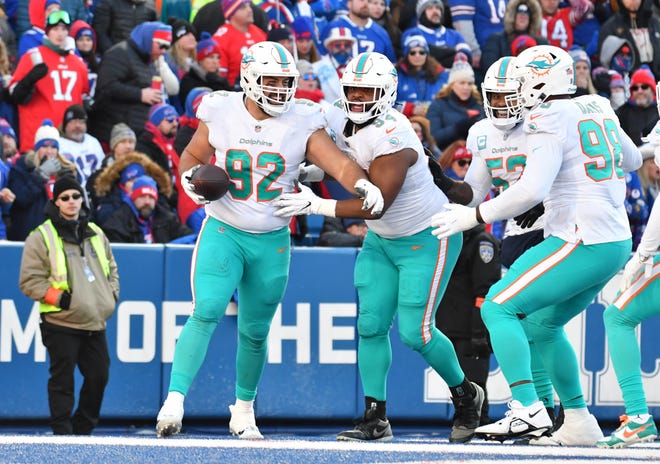 Jan 15, 2023; Orchard Park, NY, USA; Miami Dolphins defensive tackle Zach Sieler (92) recovers a fumble for a touchdown against the Buffalo Bills during the second half in a NFL wild card game at Highmark Stadium. Mandatory Credit: Mark Konezny-USA TODAY Sports