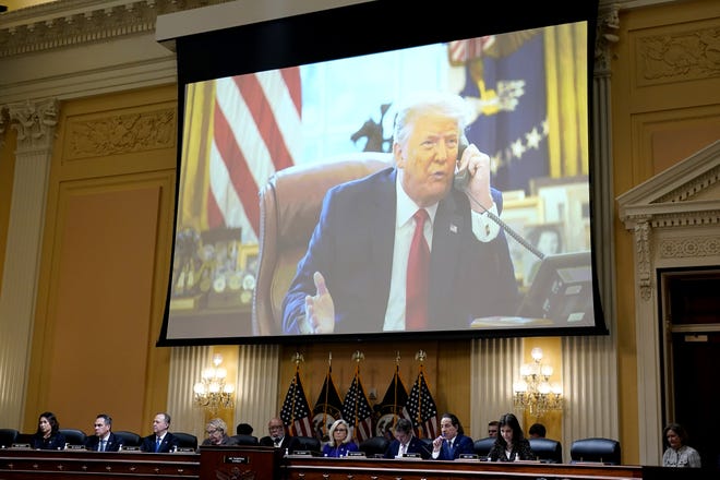 A video of former President Donald Trump is shown on a screen, as the House select committee investigating the Jan. 6 attack on the U.S. Capitol holds its final meeting on Capitol Hill in Washington, Monday, Dec. 19, 2022. From left to right, Rep. Stephanie Murphy, D-Fla., Rep. Pete Aguilar, D-Calif., Rep. Adam Schiff, D-Calif., Rep. Zoe Lofgren, D-Calif., Chairman Bennie Thompson, D-Miss., Vice Chair Liz Cheney, R-Wyo., Rep. Adam Kinzinger, R-Ill., Rep. Jamie Raskin, D-Md., and Rep. Elaine Luria, D-Va.