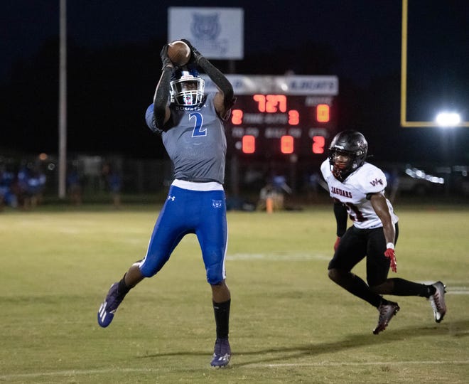 Reed Robinson (2) leaps to make the catch during the West Florida vs Washington football game at Booker T. Washington High School in Pensacola on Friday, Sept. 2, 2022.