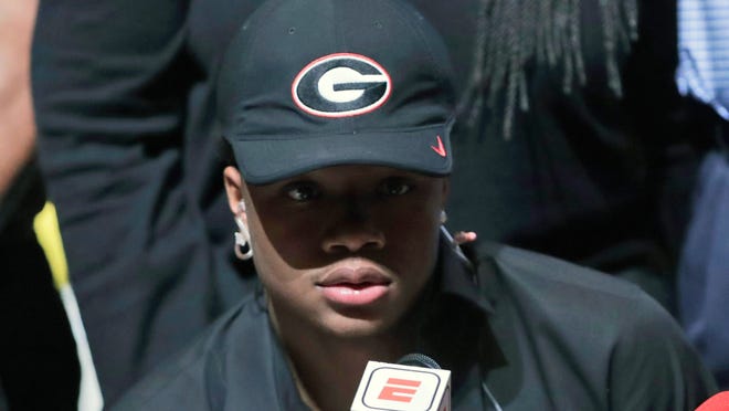 Tyson Campbell, a defensive back from the football team at American Heritage High School, announces he is signing with Georgia on national signing day, Wednesday, Feb. 7, 2018, in Plantation, Fla. (AP Photo/Lynne Sladky)