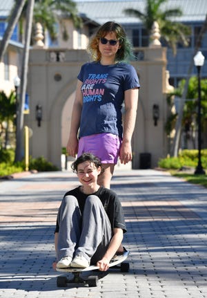 New College of Florida student Sam Sharf, standing, and her friend Claire Cwalina, visiting from Virginia, ride Sam's longboard on the New College Bayfront Campus on Monday, Jan. 9, 2023. Florida Gov. Ron DeSantis overhauled the board of Sarasota's New College on Friday, bringing in six new members in a move his administration described as an effort to shift the school in a conservative direction.