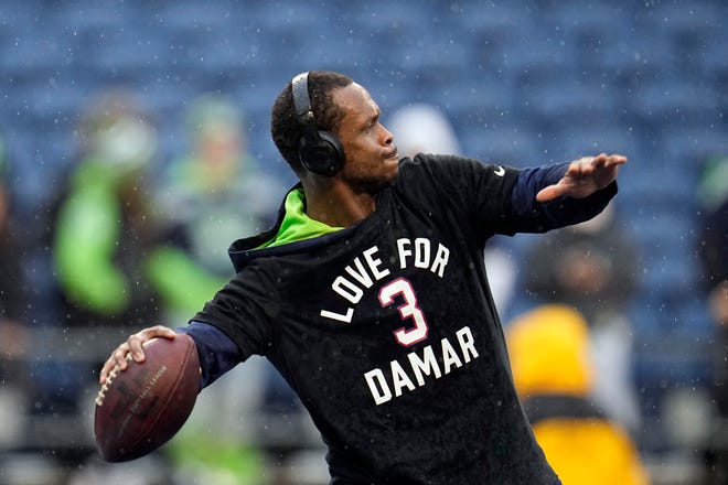 Seattle Seahawks quarterback Geno Smith warms up wearing a t-shirt with a message for Buffalo Bills safety Damar Hamlin before an NFL football game Los Angeles Rams Sunday, Jan. 8, 2023, in Seattle. (AP Photo/Abbie Parr)