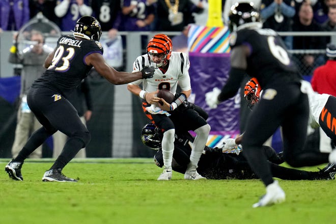 Cincinnati Bengals quarterback Joe Burrow (9) is sacked by Baltimore Ravens linebacker Jason Pierre-Paul (4) in the first quarter during an NFL Week 5 game, Sunday, Oct. 9, 2022, at M&T Bank Stadium in Baltimore.