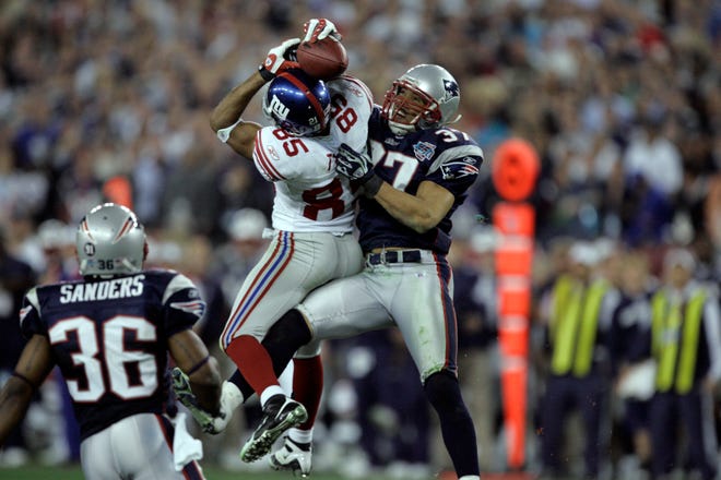 New York Giants' David Tyree #85 catches a pass against the New England Patriots' Rodney Harrison #37 during the Super Bowl XLII football game at University of Phoenix Stadium on Sunday, Feb. 3, 2008, in Glendale, Ariz.