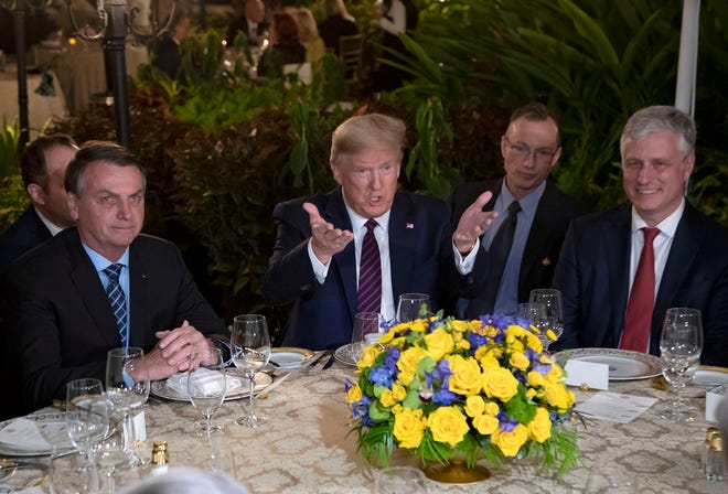 Brazilian President Jair Bolsonaro has dinner with then-President Donald Trump at Mar-a-Lago in Palm Beach in March 2020.