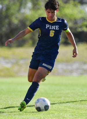 The Pine School's Julian Restrepo (6) passes the ball in the Regional 2-2A final against Lakeland Christian on Feb. 15, 2023, at the Pine School in Hobe Sound. The Pine School won 2-0.