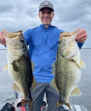 Eric Derstine of DeLand, returned to Highland Park Fish Camp with his hands full after a bass-fishing trip with Capt. James Hillman.