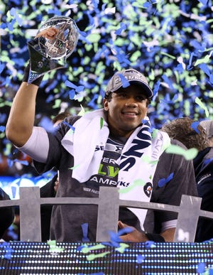 Feb. 2, 2014: Seattle Seahawks quarterback Russell Wilson celebrates with the Vince Lombardi Trophy after winning Super Bowl XLVIII against the Denver Broncos at MetLife Stadium. Seattle Seahawks won the game, 43-8.