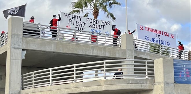 A white supremacist group gathered on the pedestrian bridge leading to Daytona International Speedway holding antisemitic banners. Daytona Beach Police Chief Jakari Young said the group is known to try to bait police into violating their speech rights so they can sue.