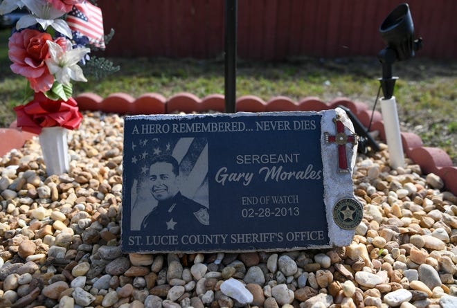 A memorial for the late St. Lucie County Sheriff's Deputy Sgt. Gary Morales is seen along the 3200 block of Naylor Terrace on Wednesday, Feb. 8, 2023, in St. Lucie County.