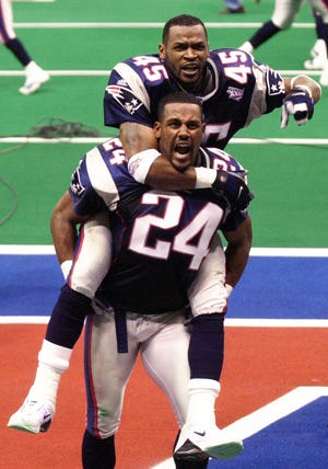 New England Patriots cornerback Otis Smith (45) celebrates on the back of teammate cornerback Ty Law (24) after the Patriots beat the St. Louis Rams in Super Bowl XXXVI at the  Louisiana Superdome Sunday, Feb. 3, 2002 in New Orleans.  (AP Photo/Tony Gutierrez)