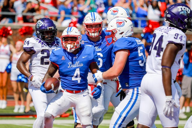 SMU running back Tre Siggers (4) reacts after scoring a touchdown against TCU during the first half of an NCAA college game on Saturday, Sept. 24, 2022, in Dallas, Texas. (AP Photo/Gareth Patterson)