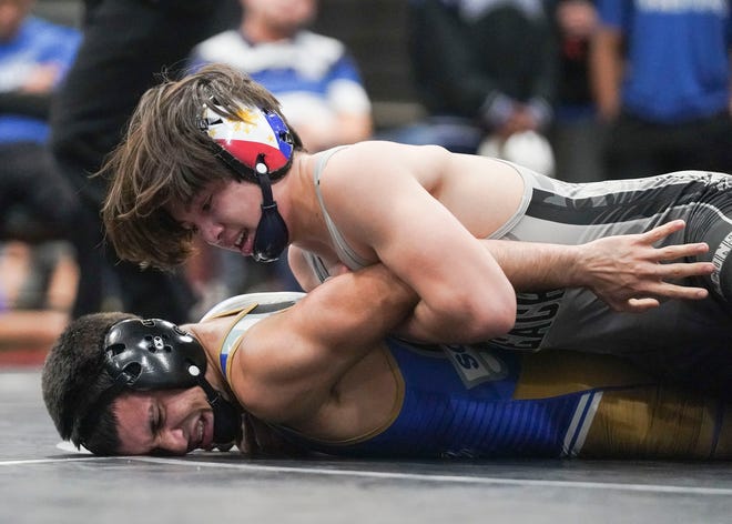 Jensen Beach's Sebastian Degennaro (top) wrestles South Dade's Luis Acevedo in the 120 pound match during the Cradle Cancer Invitational wrestling tournament on Saturday, Jan. 7, 2023, at Jensen Beach High School.