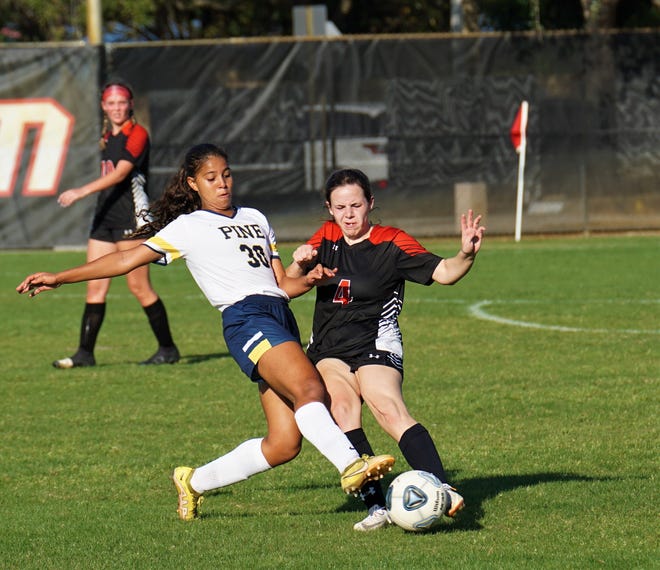 Pine School's Giovanna Waksman and Jupiter Christian's Juliana Tibbs duel for the ball during the District 8-2A championship match on Tuesday, Jan. 31, 2023 in Jupiter. Pine School won the match 3-2.